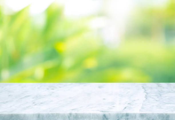 istock Selective focus.Marble table top on blur green garden background 1314543937