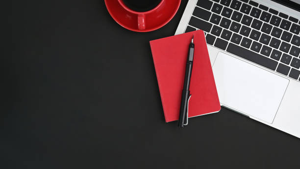 istock Black table with laptop, pen, coffee and notebook. Office desk concept. 1314544126