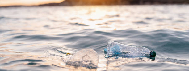istock Horizontal banner or header Garbage floating on sea or ocean water with plastic bottles and face masks. 1314544240