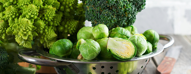 Brussels, broccoli and kohlrabi Assortment of raw cabbages fresh organic on old wood background. Healthy food concept.