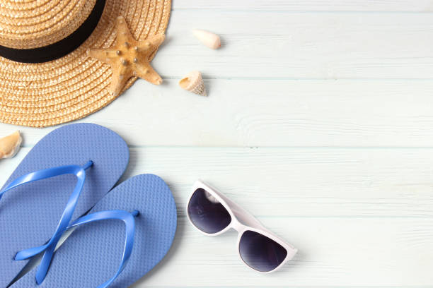 istock travel accessories and tropical leaves on a colored background top view. 1314547617