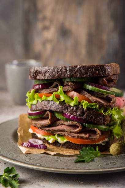 istock sandwich with rye bread, roast beef and fresh vegetables 1314547749