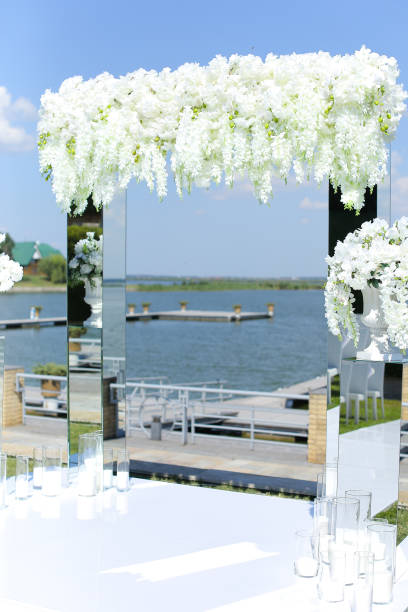 istock White nice wedding arch with lake in backround 1314548014