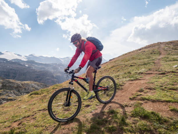 istock Man mountain biker rides along trail below the Matterhorn mountain 1314548176