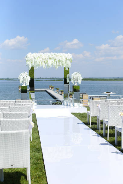 istock White amazing wedding arch and chairs near lake 1314548194