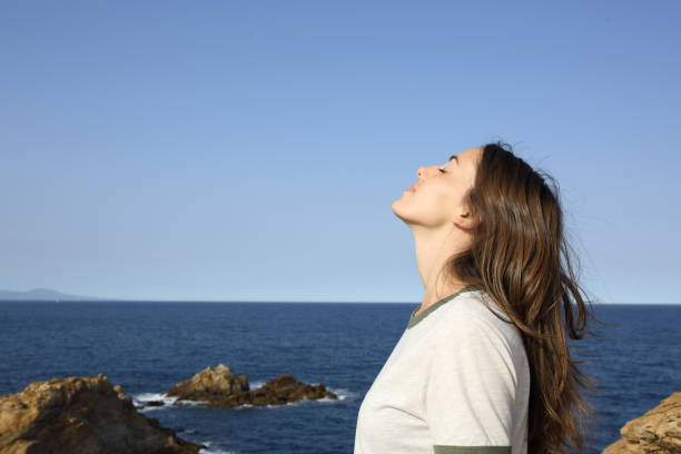 istock Woman breathing fresh air alone on the beach 1314549394