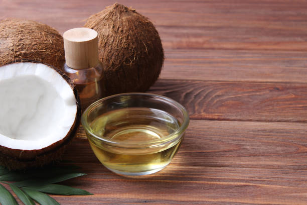 istock coconut oil and coconuts, palm branches close up 1314549753