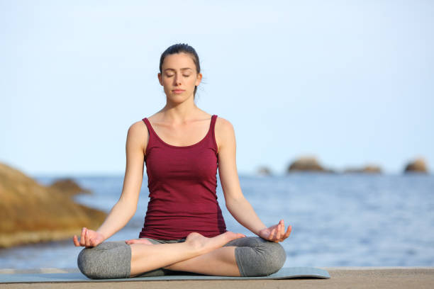istock Concentrated woman doing yoga on the beach 1314549757