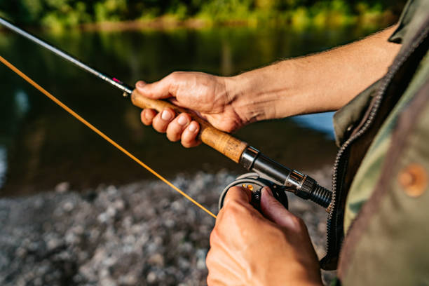 istock Man with a spinning fishing on the river 1314549807