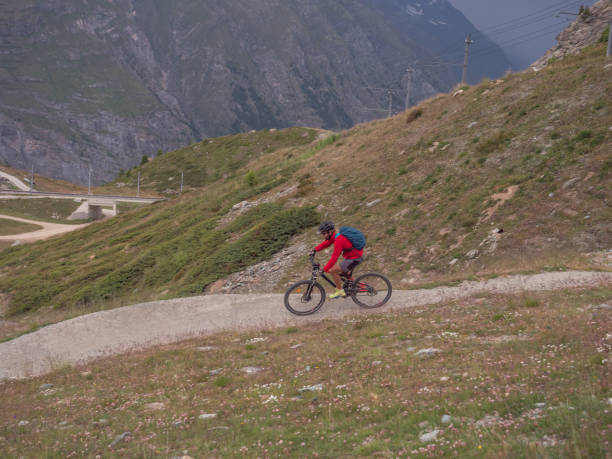 istock Man mountain biker rides along trail in Summer 1314550142
