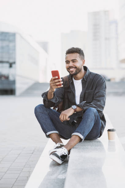 istock Handsome young man looking at smartphone on a city street 1314550199
