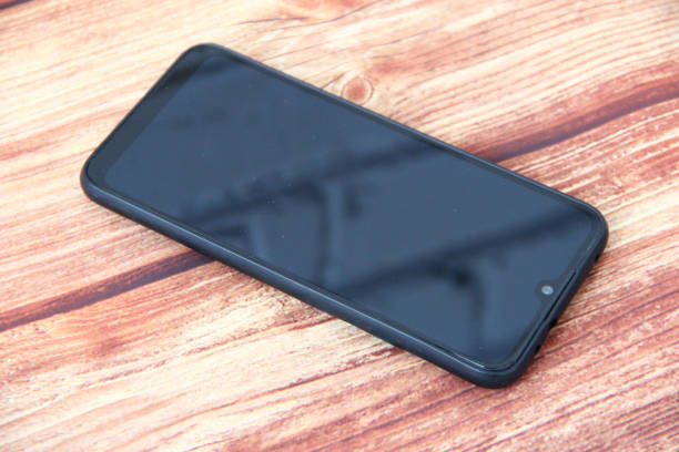 istock Black smartphone on wooden background upside down 1314551040