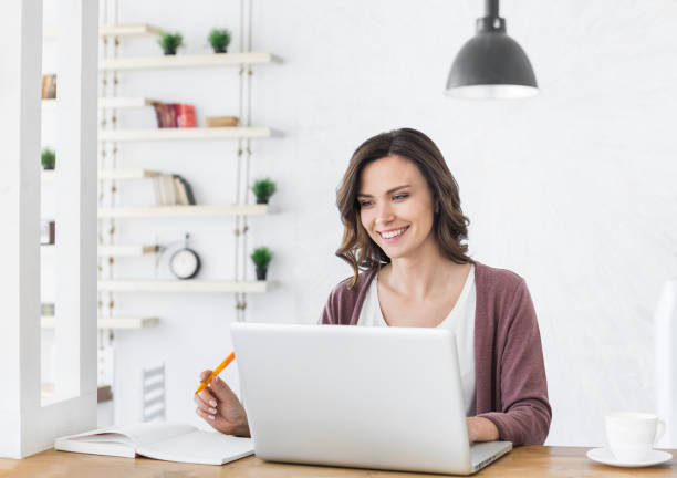 istock Woman using laptop at home. Online learning, studying, work concept 1314551229