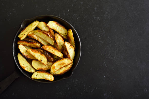 istock Fried potato wedges in frying pan 1314551402