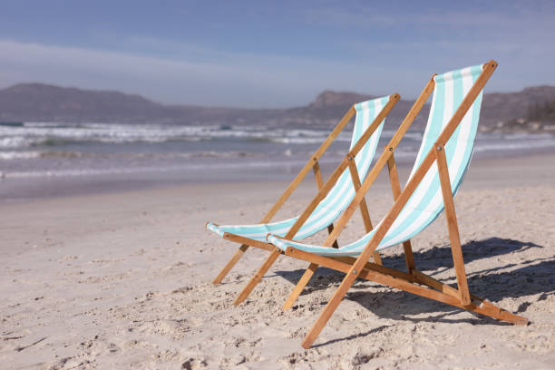 istock View of two deck chairs on the beach with sea waves 1314552578