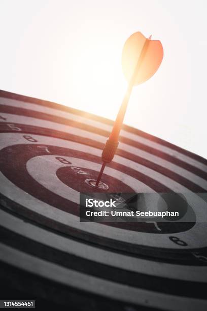 A Red Dart Is Placed In The Center Of A Circular Target Communicate The Business Success Of The Target Vertical Image Stock Photo - Download Image Now
