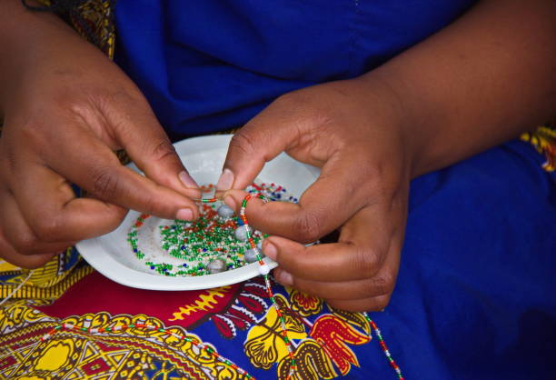 Hands of a Zulu woman doing beadwork, Zululand, South Africa Hands of a Zulu woman creating handmade jewelry with beads, Zululand, South Africa zululand stock pictures, royalty-free photos & images
