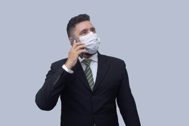 istock isolated businessman using mask to protect himself from viruses 1314560635