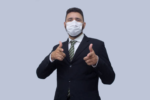 istock isolated businessman using mask to protect himself from viruses 1314560749