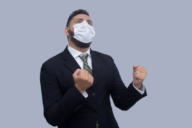 istock isolated businessman using mask to protect himself from viruses 1314560787