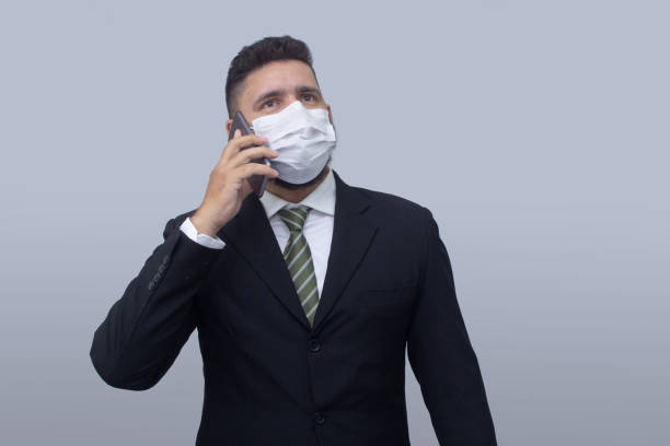 istock isolated businessman using mask to protect himself from viruses 1314560867