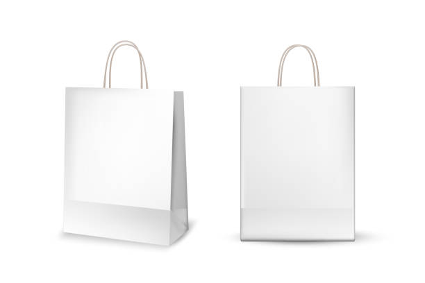 istock White cardboard bags. Blank gift or shopping package with ribbon handle vector illustration. Realistic commercial store carton bags isolated on white background 1314561431