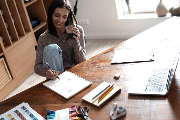 istock Indian mixed-race pretty designer working at her desk in her office. 1314561590