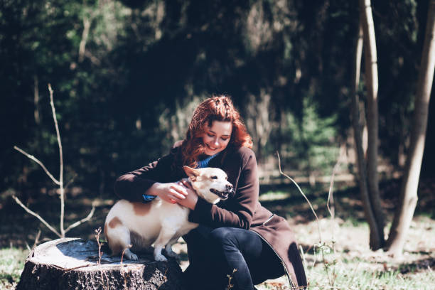 istock beautiful girl stroking her dog 1314562973