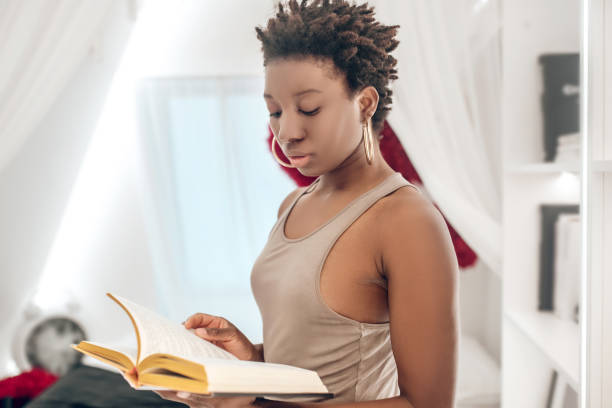 istock Elegant good-looking dark-skinned woman with a book in hands 1314565781
