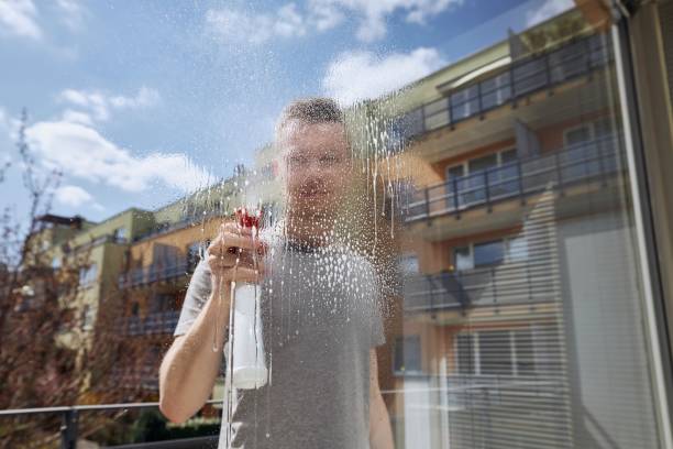istock Man cleaning window at home 1314567062