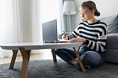 Teenage girl attending online class from home.