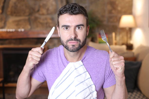 istock Hungry man holding fork and knife 1314569052