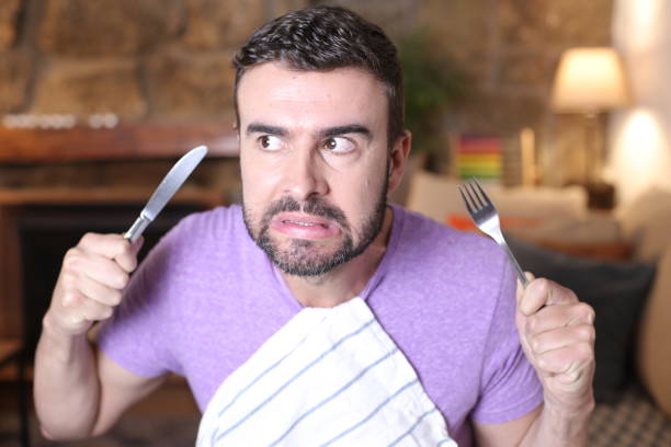 istock Hungry man holding fork and knife 1314569107