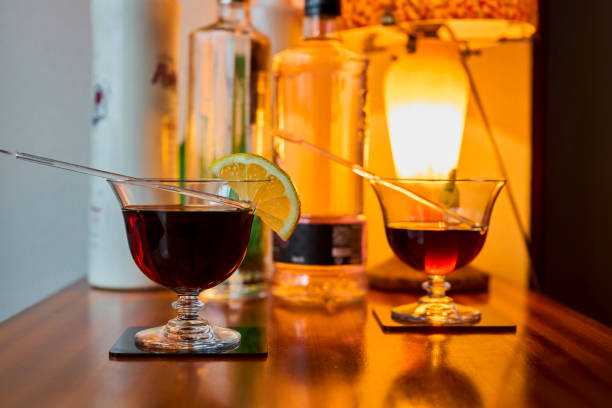 istock Cocktail glasses with vermouth and lemon, and various bottles 1314569137