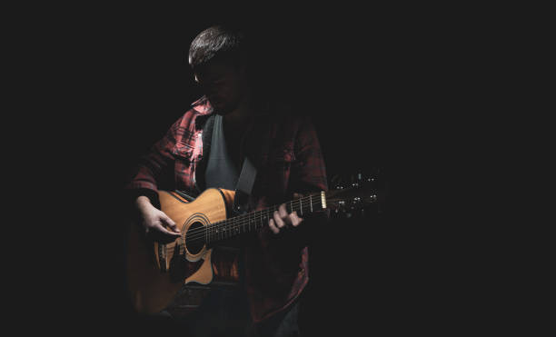 istock Male guitarist playing acoustic guitar copy space. 1314569342