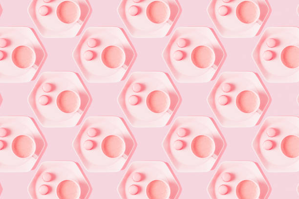 istock Pattern of coffee with macarons on pastel pink background 1314570494