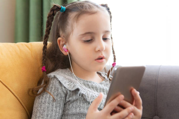 istock little girl using smart phone 1314570664