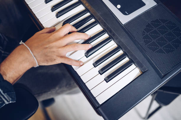 istock Pianist's hand on electronic piano keyboard, view from above. 1314570756