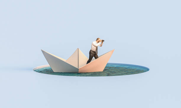 istock man with binoculars on a paper boat 1314570759