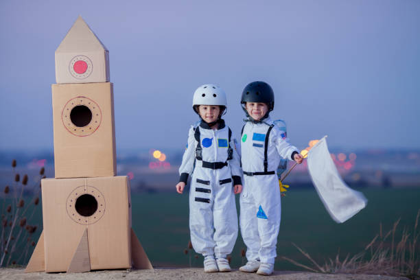 istock Two adorable children, playing in park on sunset, dressed like astronauts 1314573124