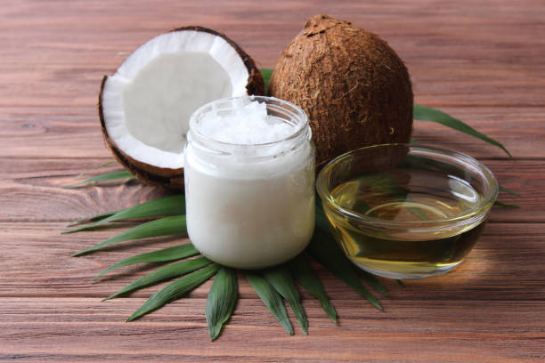 istock coconut oil and coconuts, palm branches close up 1314573256