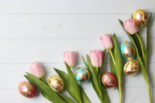 istock Easter composition of painted eggs and feathers on a colored background. 1314575643