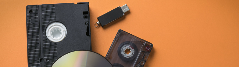 CD-ROM and video-audio cassette flash drive as a concept of media storage evolution banner.