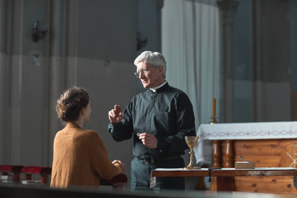 istock Priest talking to woman 1314575676