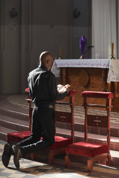 istock Catholic praying in the church 1314575702