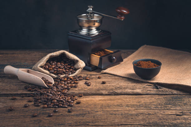 istock Coffee background with coffee grinder and beans on wooden table with copy space 1314576073