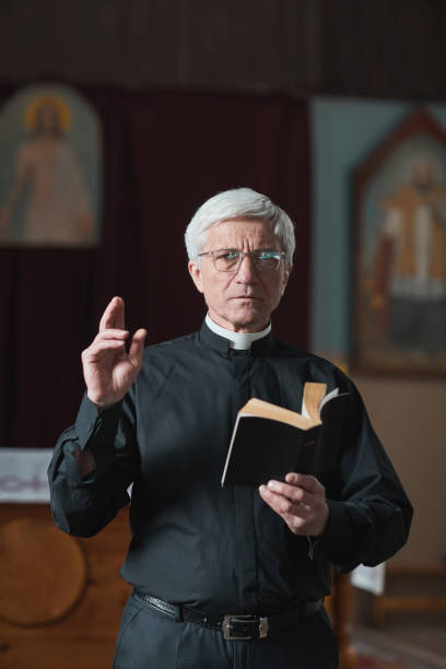 istock Senior priest reading the Bible 1314576125
