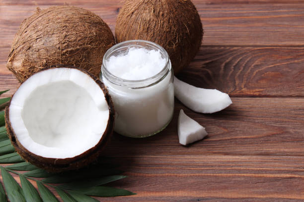 istock coconut oil and coconuts, palm branches close up 1314577060