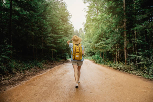 istock Woman with backpack hiking in the forest 1314577162
