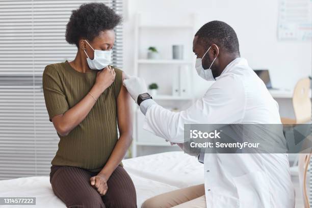 Doctor Vaccinating He Patient Stock Photo - Download Image Now - Vaccination, Pregnant, African-American Ethnicity